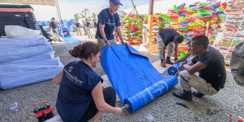 Samaritan’s Purse staff work at cutting tarp to distribute to the residents of Acapulco. 